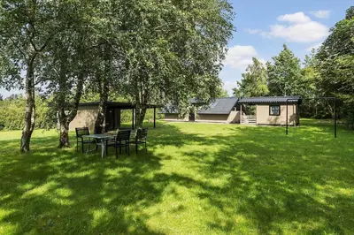 a picnic table in a yard with a house at JB273-Fjerritslev-Hasselvej-39 in Fjerritslev