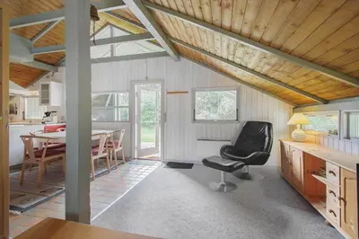 a kitchen and dining room with a table and a chair at JB329-Brovst-Egernvej-29 in Brovst