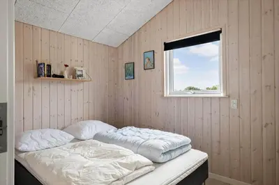 two beds in a room with a window at JB234-Frostrup-Strandvejen-83-A in Frøstrup