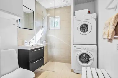 a bathroom with a washing machine and a sink at JB246-Brovst-Graevlingevej-13 in Brovst
