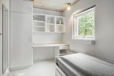 a small bedroom with a bed and a window at JB640-Fjerritslev-Bjerregardsboulevarden-8 in Fjerritslev