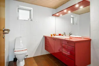 a red bathroom with a toilet and a sink at JB640-Fjerritslev-Bjerregardsboulevarden-8 in Fjerritslev