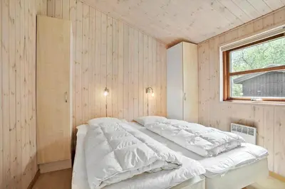 a white bed in a room with a window at JB126-Fjerritslev-Tyttebaerstien-48 in Fjerritslev