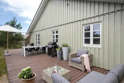 a wooden deck with chairs and a piano on a house at JB175-23-Brovst-Kronvildtvej-60 in Brovst