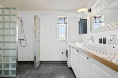 a white bathroom with two sinks and a shower at JB175-23-Brovst-Kronvildtvej-60 in Brovst
