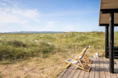 a chair sitting on top of a porch at JB119-Brovst-Ejstrup-Strandvej-18 in Brovst