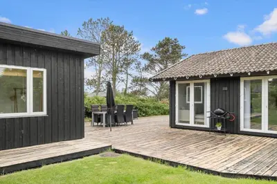 a wooden deck next to a house at JB318-Fjerritslev-Fiskerstien-10 in Fjerritslev