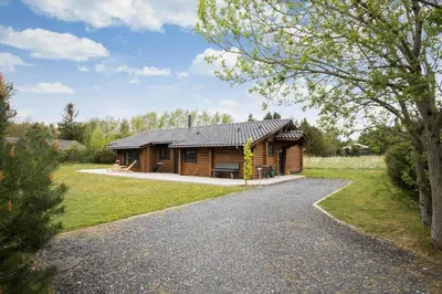 a log cabin in a field with a driveway at JB125-Fjerritslev-Lyngbjergvej-31 in Fjerritslev