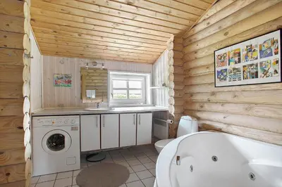 a bathroom with a tub and a sink and a washing machine at JB125-Fjerritslev-Lyngbjergvej-31 in Fjerritslev