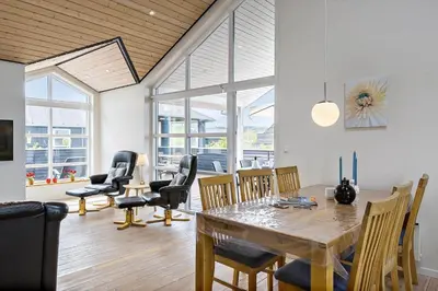 a dining room with a table and chairs at JB187-Brovst-Kronvildtvej-128 in Brovst