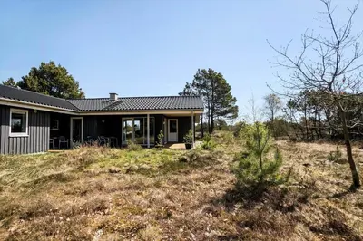 a house on top of a grass covered hill at JB102-Fjerritslev-Blabaerstien-7 in Fjerritslev