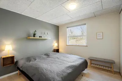 a bedroom with a large bed and a window at JB666-Fjerritslev-Aspevej-21 in Fjerritslev