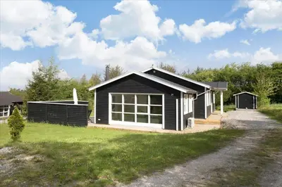 a black and white house with a yard at JB666-Fjerritslev-Aspevej-21 in Fjerritslev