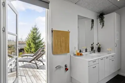 a white bathroom with a sink and a sliding glass door at JB666-Fjerritslev-Aspevej-21 in Fjerritslev