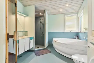 a bathroom with a tub and a toilet and a sink at JB759-Fjerritslev-Revlingestien-45 in Fjerritslev