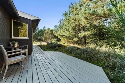 a wooden deck with a bench on a house at JB759-Fjerritslev-Revlingestien-45 in Fjerritslev