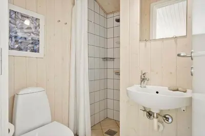 a bathroom with a white toilet and a sink at JB696-Fjerritslev-Blabaerstien-56 in Fjerritslev