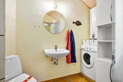 a bathroom with a sink and a washing machine at JB304-Fjerritslev-Landstien-4 in Fjerritslev