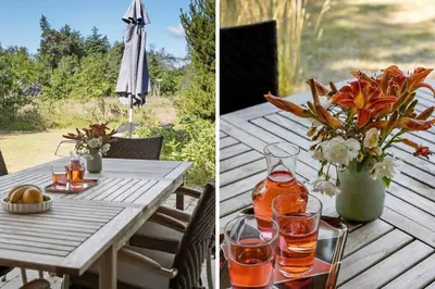 a picnic table with a vase of flowers and an umbrella at JB304-Fjerritslev-Landstien-4 in Fjerritslev