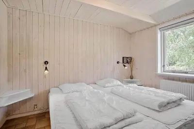 a bedroom with a large white bed in it at JB182-Fjerritslev-Gyvelstien-39 in Fjerritslev