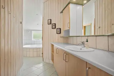 a bathroom with a sink and a mirror and a tub at JB182-Fjerritslev-Gyvelstien-39 in Fjerritslev
