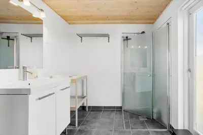 a bathroom with a shower and a sink and a toilet at JB203-Brovst-Kronvildtvej-35 in Brovst