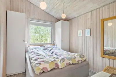 a bedroom with a bed and a window at JB122-Fjerritslev-Tyttebaerstien-14 in Fjerritslev