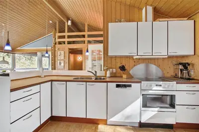 a kitchen with white cabinets and a sink at JB154-Fjerritslev-Bredvandet-34 in Fjerritslev
