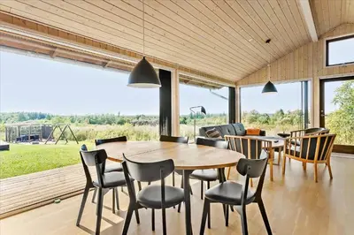a dining room with a wooden table and chairs at JB177-Fjerritslev-Aspevej-44 in Fjerritslev