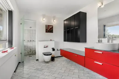 a bathroom with a red cabinet and a sink and a toilet at JB325-Frostrup-Bulbjergvej-40 in Frøstrup
