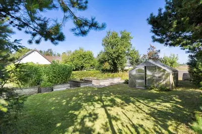 a garden with a greenhouse in a yard at JB325-Frostrup-Bulbjergvej-40 in Frøstrup