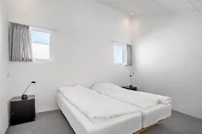 a white room with a bed and two windows at JB129-Brovst-Strandvejen-150-Lejl-106 in Brovst