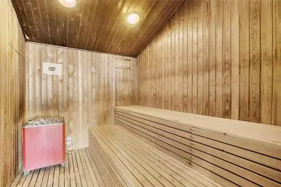 a wooden sauna with a red trash can in it at JB129-Brovst-Strandvejen-150-Lejl-106 in Brovst