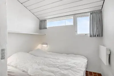a white bed in a room with a window at JB129-Brovst-Strandvejen-150-Lejl-106 in Brovst