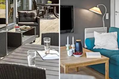 a living room with a blue couch and a table at JB328-Brovst-Kronvildtvej-184 in Brovst