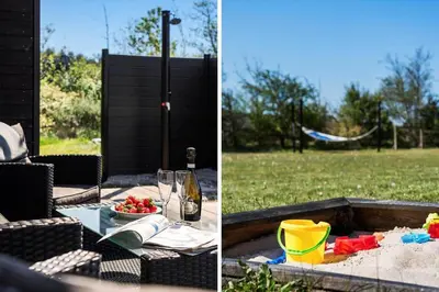 a picnic table with a bottle of wine and a plate of food at JB328-Brovst-Kronvildtvej-184 in Brovst