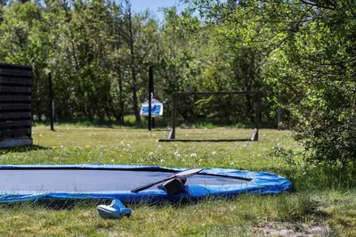 a blue kite laying on the grass in a field at JB328-Brovst-Kronvildtvej-184 in Brovst