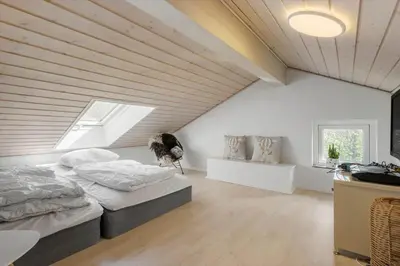a attic bedroom with a bed and a window at JB161-Brovst-Kronvildtvej-206 in Brovst