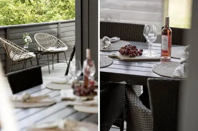 a table with wine glasses and grapes on a deck at JB161-Brovst-Kronvildtvej-206 in Brovst
