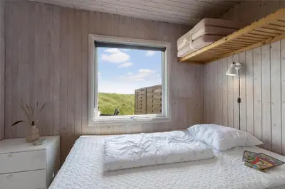 a bedroom with a bed and a window at JB233-Brovst-Ejstrup-Strandvej-24 in Brovst