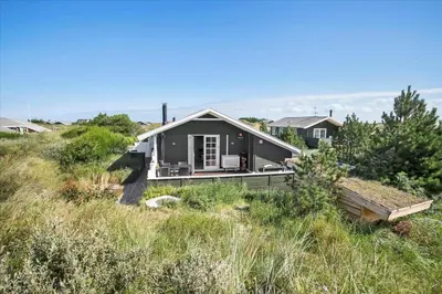 a small black house on a hill in a field at JB116-Frostrup-Svenstibakkevej-30 in Frøstrup