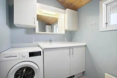a laundry room with a washing machine and a sink at JB173-Brovst-Redningsvejen-28 in Brovst