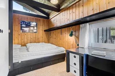 a bedroom with a bed in a wooden wall at JB987-Fjerritslev-N-C-Alstedsvej-12 in Fjerritslev