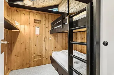 a bunk bed in a cabin with wooden walls at JB987-Fjerritslev-N-C-Alstedsvej-12 in Fjerritslev