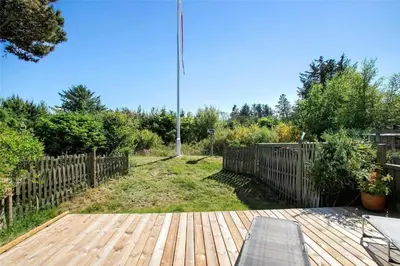 a wooden deck with a fence in a yard at JB137-Fjerritslev-Markstien-15 in Fjerritslev