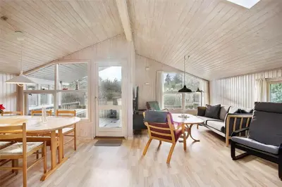 a living room with a table and a couch at JB137-Fjerritslev-Markstien-15 in Fjerritslev