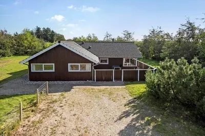 a house with a fence in front of it at JB223-Brovst-Kronvildtvej-18 in Brovst