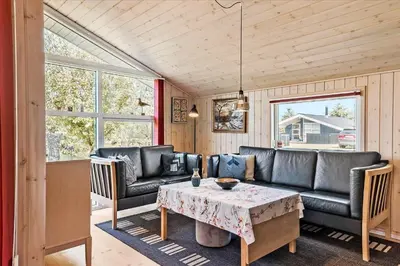 a living room with a couch and a table at JB166-Fjerritslev-Egevej-26 in Fjerritslev