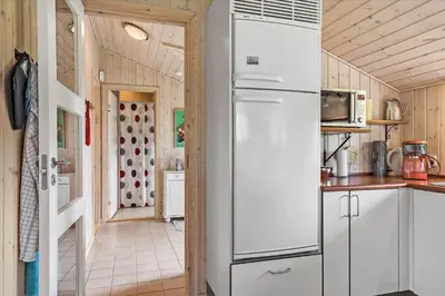 a kitchen with a white refrigerator and a hallway at JB166-Fjerritslev-Egevej-26 in Fjerritslev