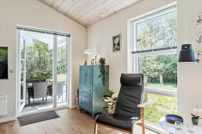 a living room with a chair and a table at JB165-Fjerritslev-Ostersvej-16 in Fjerritslev